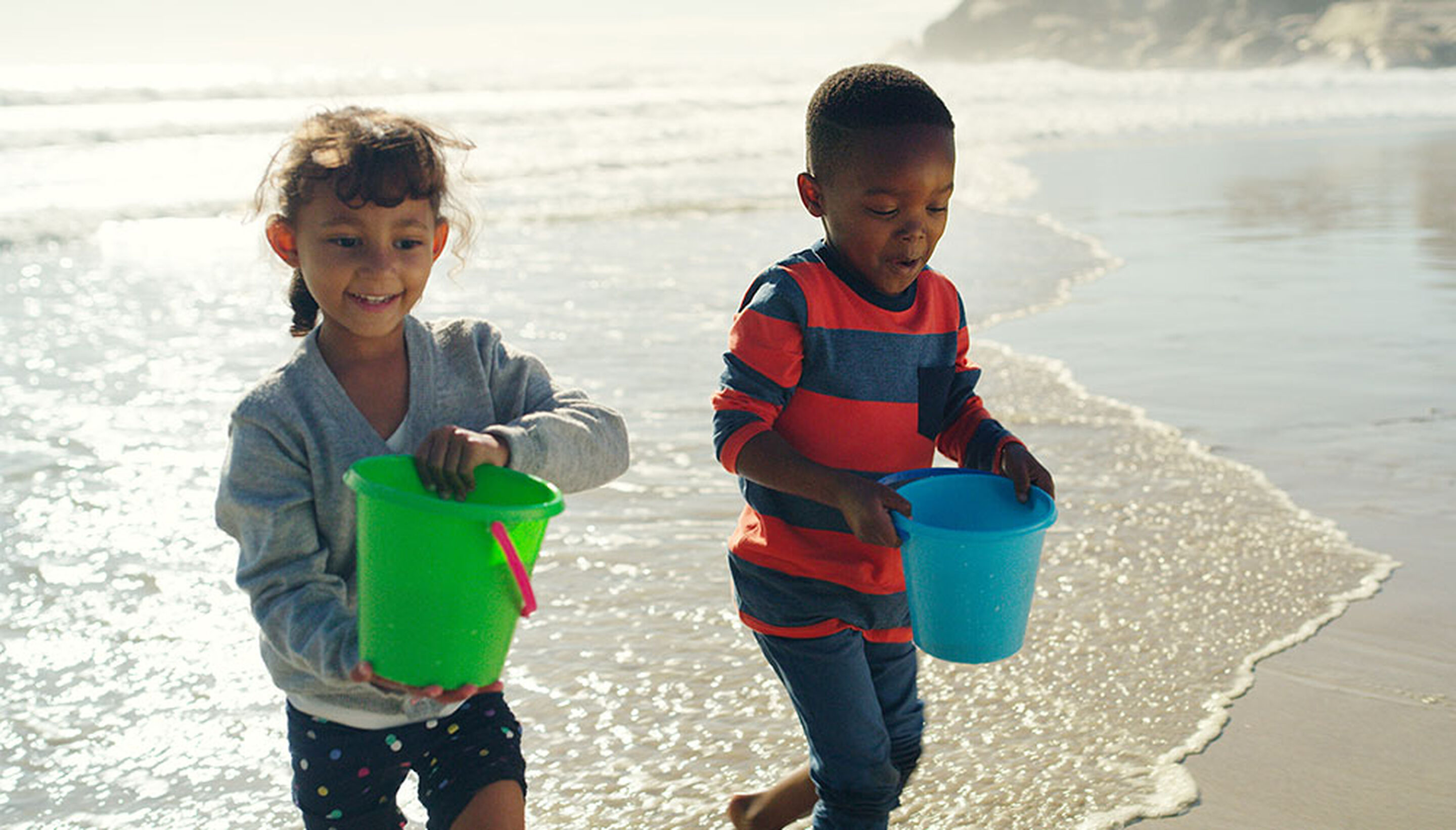 Beach games for kids – playing with a ball near the water